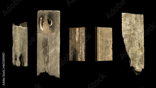 a collection of five old vintage sawn wooden planks on a black background with an retro texture