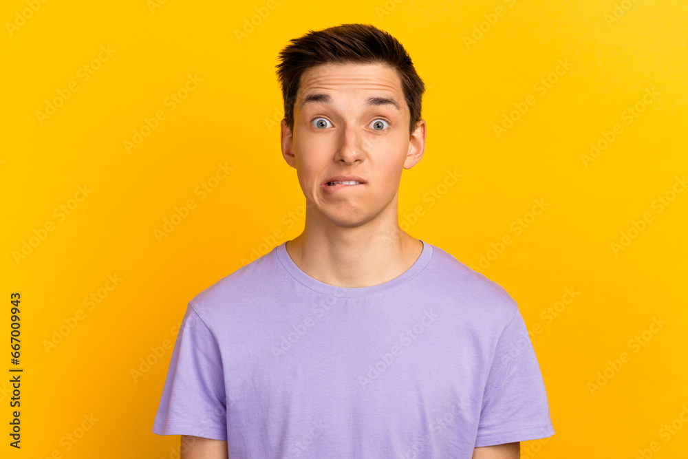 Close-up portrait of attractive funny confused brunet guy wearing tshirt waiting news biting lip isolated over bright color background Close-up portrait of attractive funny confused brunet guy wearing tshirt waiting news biting lip isolated over bright color background