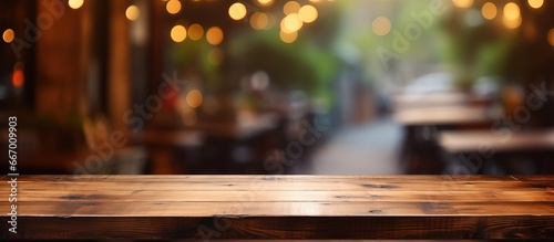 Blurry background of a coffee shop with a wooden table in focus perfect for showcasing a product photo