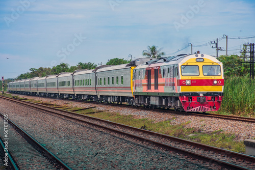 Passenger train by diesel locomotive on the railway.