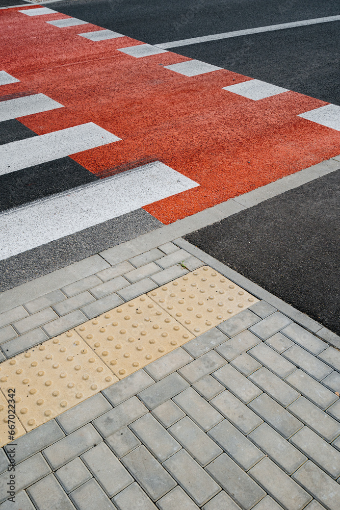 Pedestrian crossing with new white stripes on gray asphalt in city