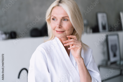 Mature woman has pure healthy skin after cleansing and using cream