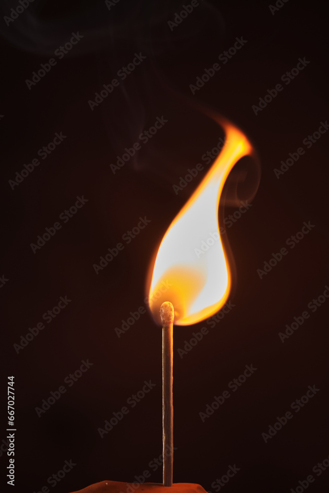 a lighted match on a dark background a lighted match on a dark background