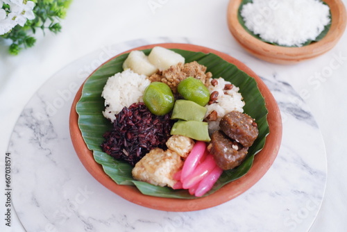 Jenang Madura is a typical Indonesian food that consists of black sticky rice, porridge marrow, jenang grendul and red pearls that were given palm sugar and coconut milk photo