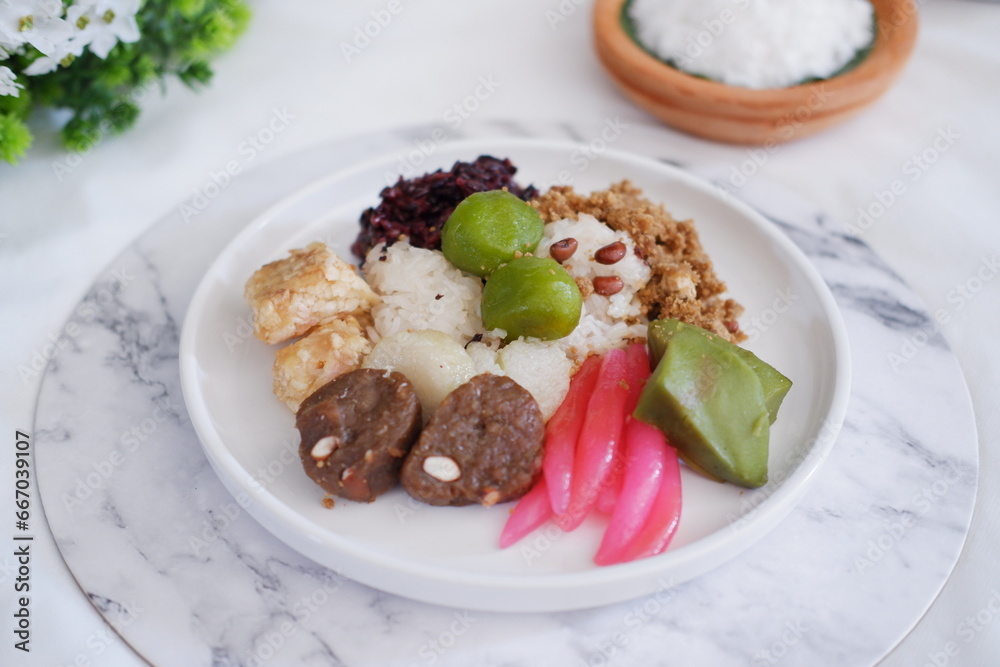 Jenang Madura is a typical Indonesian food that consists of black sticky rice, porridge marrow, jenang grendul and red pearls that were given palm sugar and coconut milk Jenang Madura is a typical Indonesian food that consists of black sticky rice, porridge marrow, jenang grendul and red pearls that were given palm sugar and coconut milk