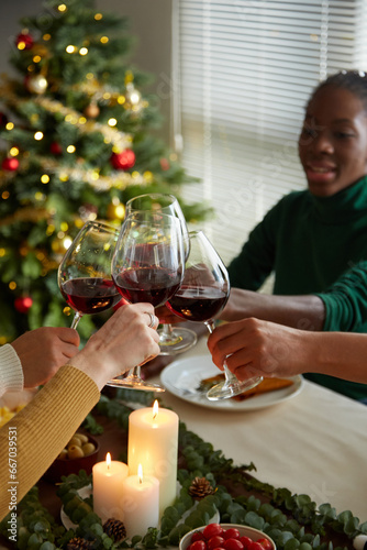 Friends toasting at Christmas party celebrating holiday at home