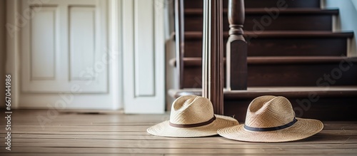 Straw hats on wooden table in home hallway