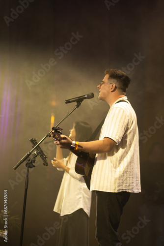 Wallpaper Mural A duet of singers is performing a song on stage. Worship band sings and worships God in the church. Church service. Torontodigital.ca