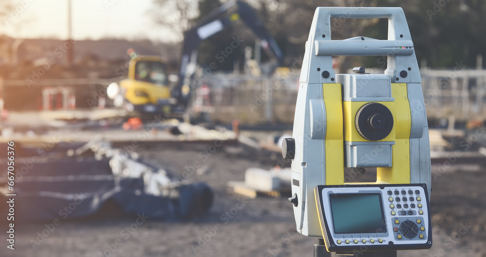Close-up of surveyor optical equipment  tacheometer or theodolite on construction site with selective focus and blurred background toned image - obrazy, fototapety, plakaty 