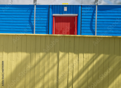 Yellow and blue wooden walls and red wooden door