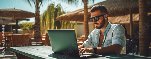 Freelancer Working Outdoors at Tropical Cafe photo
