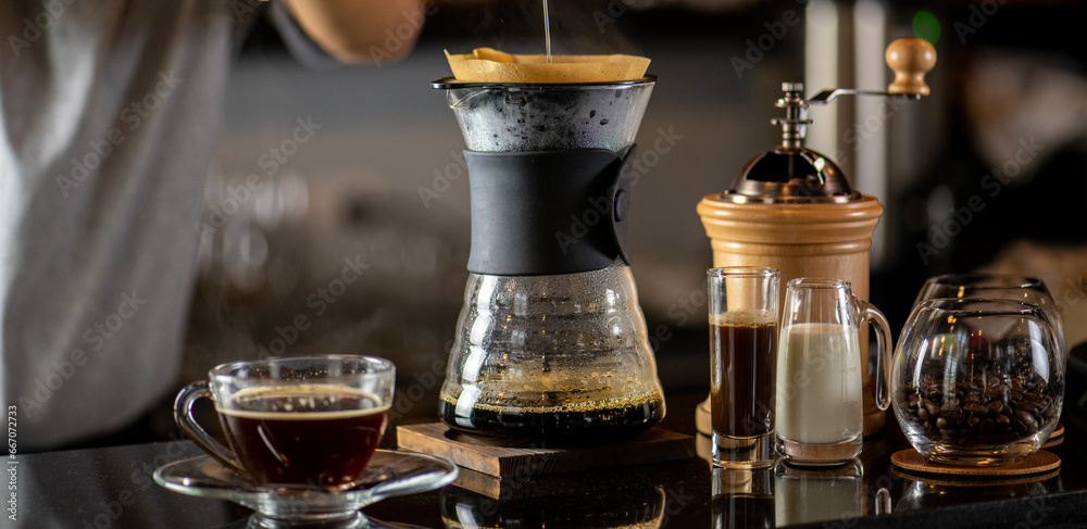 drip coffee, Barista making drip coffee by pouring spills hot water on coffee ground with prepare filter from copper pot to glass transparent chrome drip maker on wooden table in cafe shop drip coffee, Barista making drip coffee by pouring spills hot water on coffee ground with prepare filter from copper pot to glass transparent chrome drip maker on wooden table in cafe shop