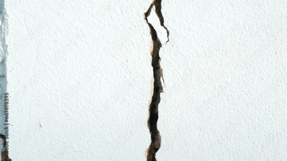 Cracks in the cement wall White cement of buildings damaged by earthquakes