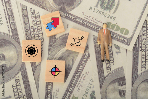 In a representation of business strategy, the businessman solved the puzzle while cogwheels turned, aiming at the target symbol.