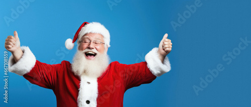 Santa claus showing thumbs up on blue background