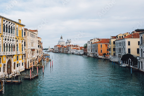 Famous view of Venice Grand Canal with Saint Mary of Health dome on sunny day from Ponte dell'Accademia bridge. Italian travel destination and landmark, tourist attraction. © Iryna