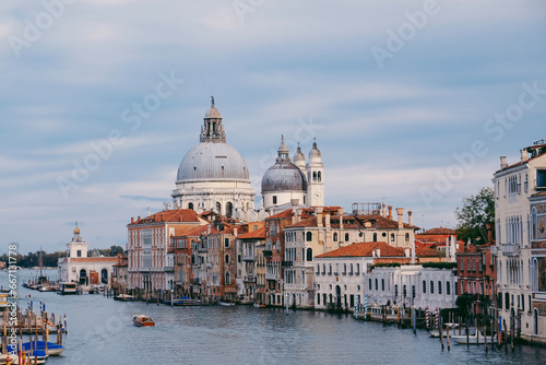 Famous view of Venice Grand Canal with Saint Mary of Health dome on sunny day from Ponte dell'Accademia bridge. Italian travel destination and landmark, tourist attraction.