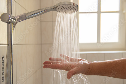 Water from a shower head, limiting water consumption and hygiene, rising energy prices. © Show_low