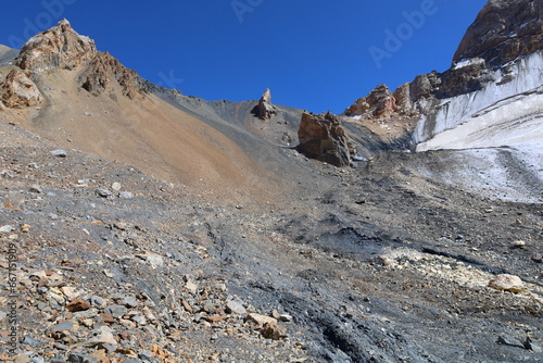 Rocky and glacial mountain landscape on a hiking trail from Iskandarkul to Chimtarga in Fann mountains, Tajikistan photo