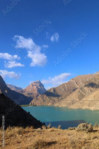 Turquoise mountain lake Iskandarkul located in Fann mountains, Sughd, Tajikistan photo