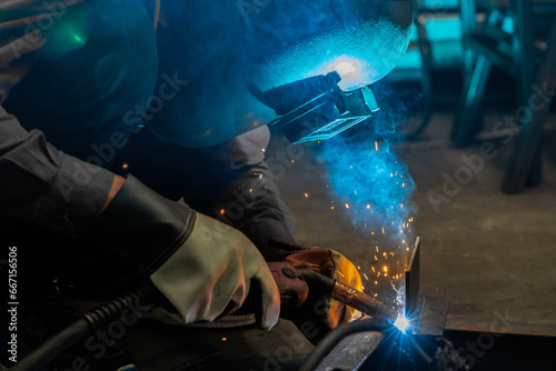 Male welder in steel welding factory.