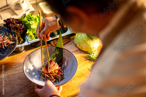 Close up of a chef preparing a sushi meal photo