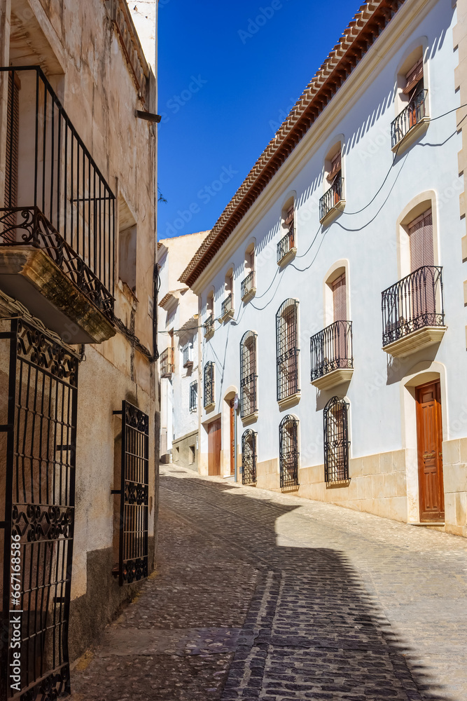 Picturesque streets with whitewashed houses and barred windows in the Andalusian village of Velez Rubio.