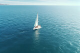 Full view of a white Sailboat on the ocean at daytime 
