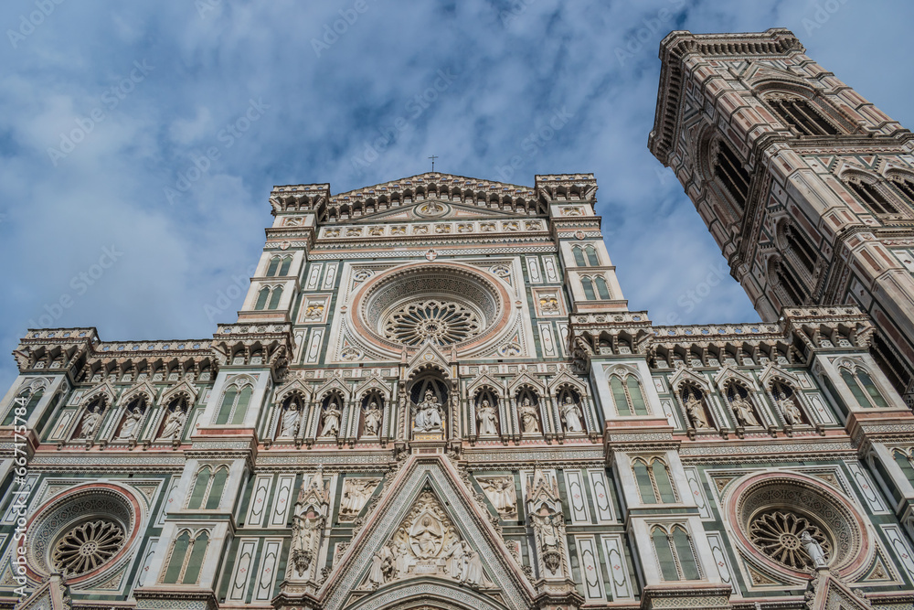 Detail of the facade of the Santa Maria del Fiore cathedral with Gothic rose windows and Giotto's bell tower, Florence ITALY