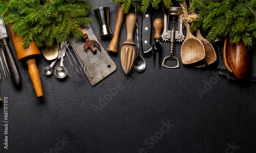 Kitchen utensils and fir tree branches on cooking table. Christmas cooking concept photo