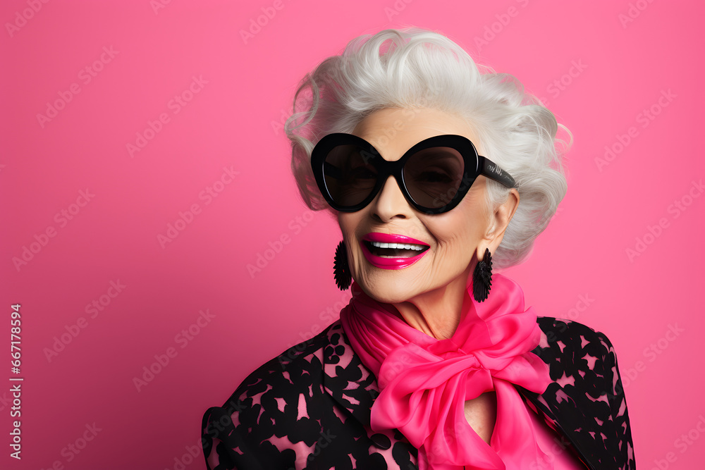Fashionable elderly woman isolated on pink