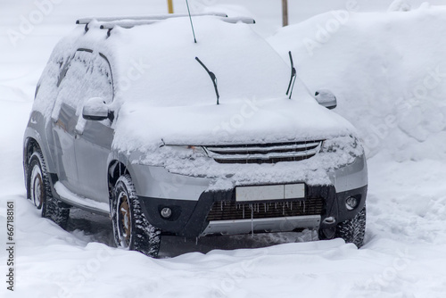 The car is covered with snow in the yard. Snowdrifts and freezed vehicles. Extreme weather conditions © sergofan2015