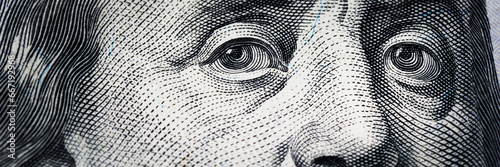 Benjamin Franklin's eyes from a hundred-dollar bill. The eyes of Benjamin Franklin on the hundred dollar banknote, backgrounds, close-up. 100 dollar bill with only eyes of Benjamin Franklin. photo