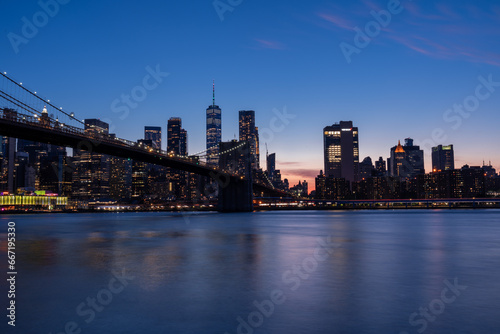 Photograph of Brooklyn Bridge, early evening, bluish light. © charles