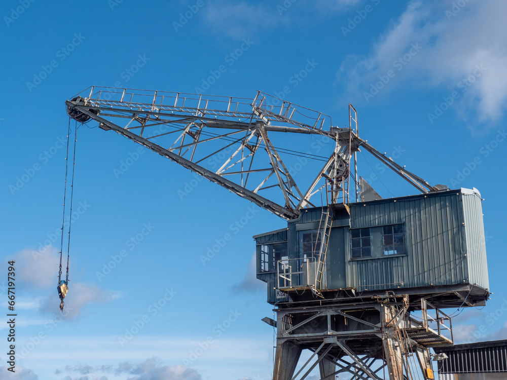Old nostalgic port wooden crane against the blue sky Old nostalgic port wooden crane against the blue sky