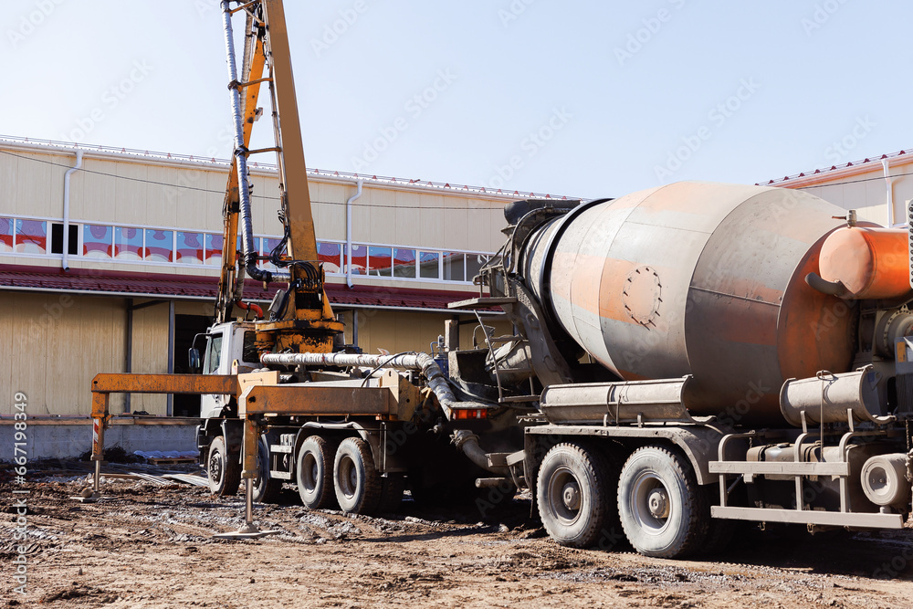 Mixer concrete move cement mortar to pump truck working on construction building site