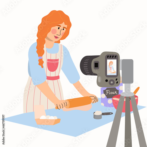 The young woman rolls out the dough. Cooking blog.Woman blogger recording video on camera, using tripod, posting it on social media.