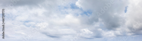 Panoramic grey sky with small blue sky patches photo