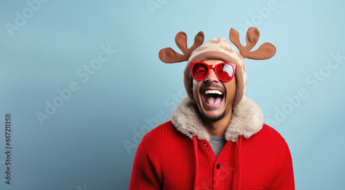 Reindeer Games - Young man wearing reindeer antlers and a red nose, laughing heartily, against a solid color background - AI Generated photo
