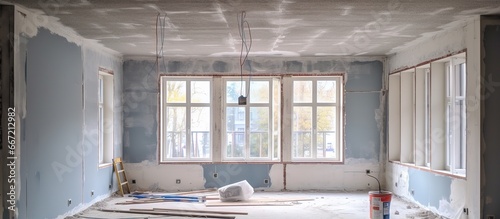 Home repair involves construction puttying and leveling walls as well as installing gypsum board ceilings photo