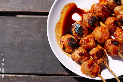 grilled pentol or meat ball with barbecue sauce photo
