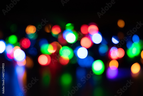 Festive Christmas and New Year background with bokeh, blurred lights on black background
