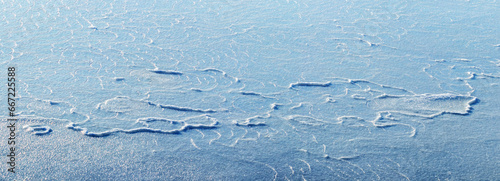 Ice texture on the river in bright sunlight, panorama