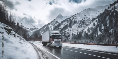 Truck on the road with snow covered mountains in the background.