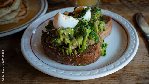 Canvas Print Photograph of avocado toast on a white plate, an appetising and fancy dish
