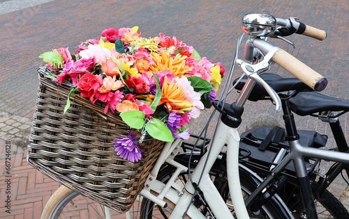 Colorful flowers in a basket on a bicycle in close-up. Eindhoven, The Netherlands.