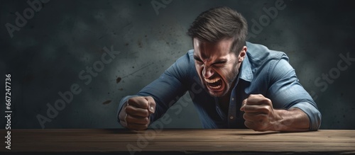 Man forcefully strikes table in anger demonstrating impatience and emotional outburst photo