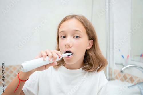 Dental hygiene. Happy little blonde girl brushing her teeth. Healthy concept