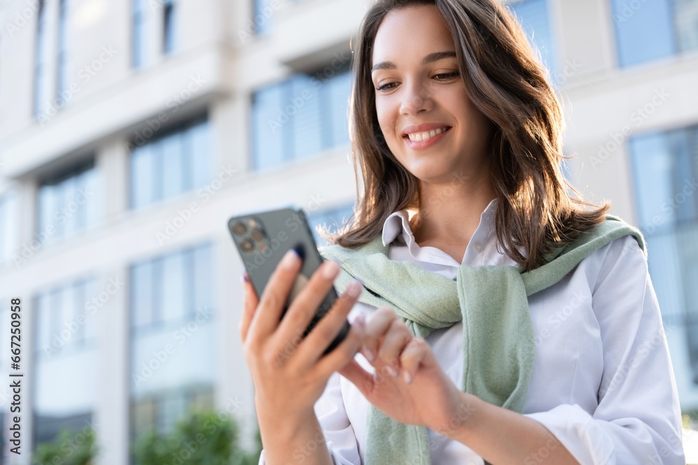 Young business woman wearing professional look smiling confident at the city using smartphone. Young business woman wearing professional look smiling confident at the city using smartphone.