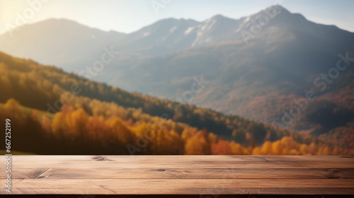 Empty wooden table top with autumn forest and mountains at background. Copy space © Neira